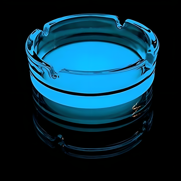 A blue glass ashtray reflecting light, showcasing its elegant design and capturing the play of colors