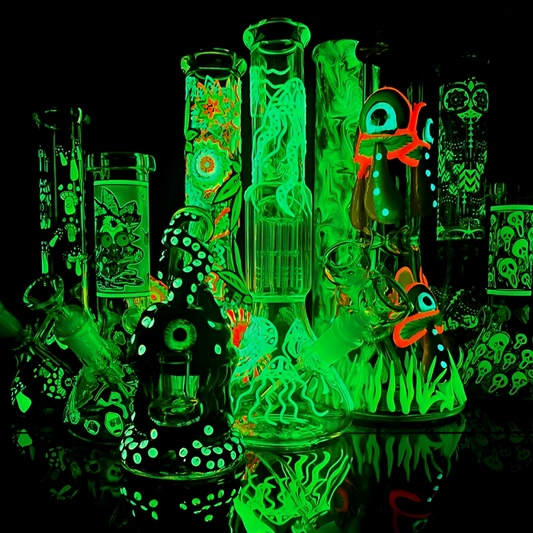 a group of glass bongs with green lights