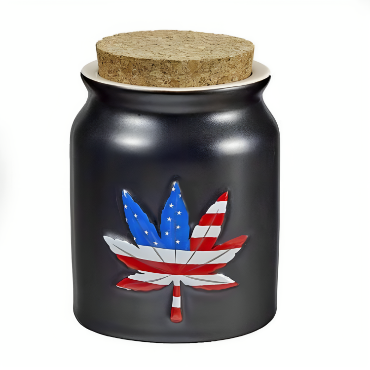 a black jar with a red white and blue leaf on it